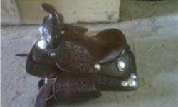 12 inch youth western saddle in excellent condition,lots of silver for showing and very comfortable.