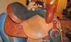 15 " medium oil Tex Tan barrel saddle with suede seat, rough-out fenders and aluminum stirrups.
Had maybe 25 rides in it.
Too big for me.
It would be a great trail riding saddle as well.