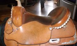 16" Western Rawhide saddle for sale. Full QH bars. Light oil but has darkened a little with age. Very comfortable saddle. Excellent condition - always been well oiled and stored in a padded bag when not in use. Has silver conchos and silver on skirt.