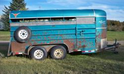 Offering our stock trailer for sale, structurally sound, tires good, with spare. 6000# tandem axles, center divider, floor has always been covered with rubber matting, back door slides or fully opens. Lights and brakes work. Needs a paint job.