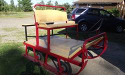 Wood & metal sleigh, seats up to 4 people.  Rear seat is removeable for hauling other items.  Includes single horse shaft.  Very light and will fit in the back of a pick up truck.  Sleigh has small wheels attached to the runners to make it easier to go