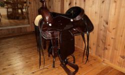 $1750 OBO    This is a brand new saddle including reins, bridle, and cinch.  It's custom and handmade.  I'm unsure of what the size maybe around 17 to 18".  It's a beautiful set.  For more info call 403-394-5238.