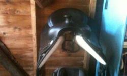 English leather saddle fits QHs and has a larger gullet, comes with stirrup irons.
The western synthetic has nickel conches, and a 15 inch seat. Full QH bars. Its light weight. It's has only had a few rides on it, and has a scratch by the horn. Was $250