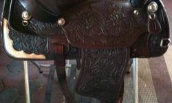 This is a 16" Western Rawhide show saddle, in excellent condition as it has minimal use only.  Comes with matching breast strap which is also tooled.  The leather is top quality.  $500.  call 705-788-1169.  located near Huntsville