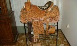 IF THE AD IS UP THE ITEM IS AVAILABLE
Unique designed 16 inch western all-around ranch saddle. 
Can be used for roping. 
Rawhide-covered  #1 heavy grade leather, tooling done by hand (no presses). 
Full desert flower design exceptionally done. 
Swells