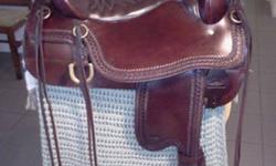 TUCKER/CIRCLE Y CHEYENNE TRAIL SADDLE IN AWESOME CONDITION.Tooled, brown16 inch western sizing/17" Tucker sizing(160-250lbs) GEL-CUSH seat, Semi 1/4 horse tree(Med.) Only used a handful of times! Call for more info at 403-637-2416.Thanks for looking.